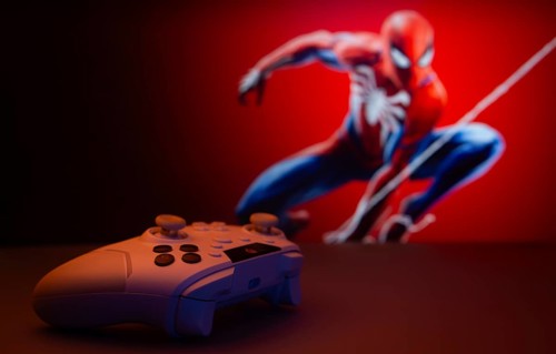 Dhaka, Bangladesh- 13 Sep 2025: Game controller in front of Marvel's Spider Man on a background