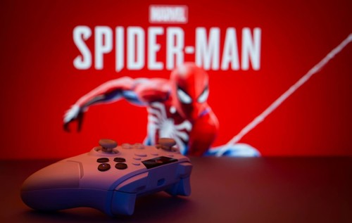 Dhaka, Bangladesh- 13 Sep 2025: Game controller in front of Marvel's Spider Man on a background