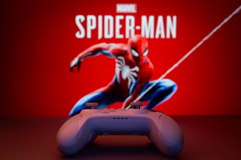 Dhaka, Bangladesh- 13 Sep 2025: Game controller in front of Marvel's Spider Man on a background