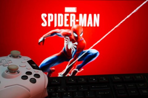 Dhaka, Bangladesh- 13 Sep 2025: Game controller in front of Marvel's Spider Man on a background
