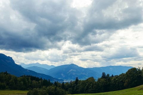 Dramatic clouds over mountains and forests in a valley, Gesäuse, Styria, Austria