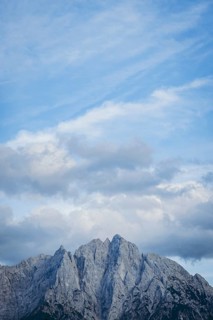 Imposing mountain peak of the Ödstein against a cloudy blue sky, Gesäuse, Styria, Austria