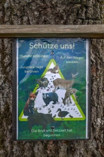 Protecting animals, a poster on a bBum at the edge of a forest, Franconia, Bavaria, Germany