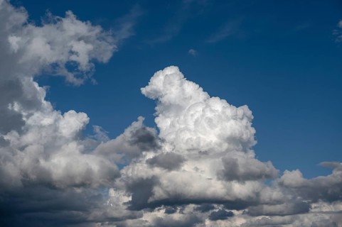 Cluster clouds (cumulus), rain clouds (nimbostratus) on the left, Bavaria, Germany