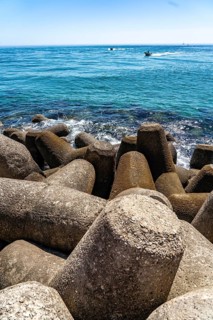 Coastal fortification at the beacon to the harbour entrance on the kilometre-long beach Praia da