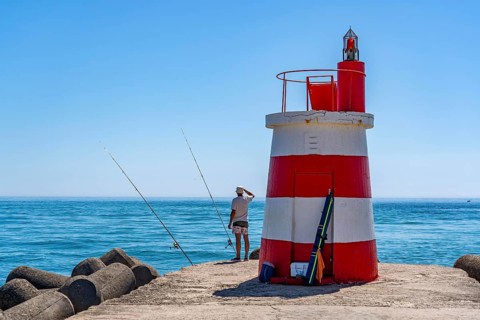 Lighthouse at the kilometre-long beach Praia da Ilha de Tavira, on the island in front of Tavira,