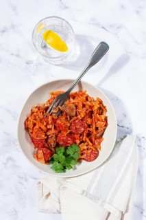 Bigos, Polish dish bigos, on a marble table, stewed meat with cabbage, chorizo sausages, mushrooms,