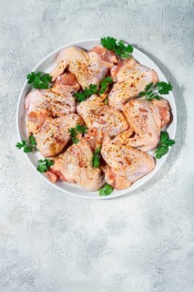 Marinated chicken wings prepared for grilling with spices and fresh herbs ready for cooking