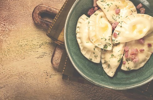 Dumplings, with fried prosciutto, a traditional dish of Polish cuisine, dumplings, top view,