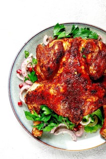 Whole fried chicken, with spices, grilled chicken, on a light background, top view, homemade, no
