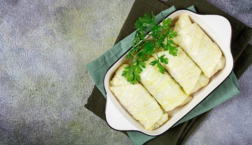 Raw cabbage rolls, not cooked, with minced meat, top view, without people, in the spotlight