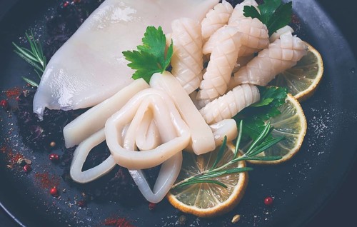 Fresh squid, raw, carcass, cut into rings, top view, no people