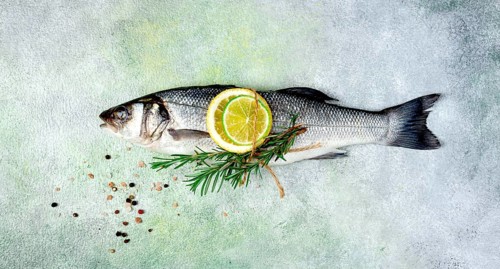 Fresh, raw, sea bass fish, with spices and citrus fruits, one piece, top view, no people
