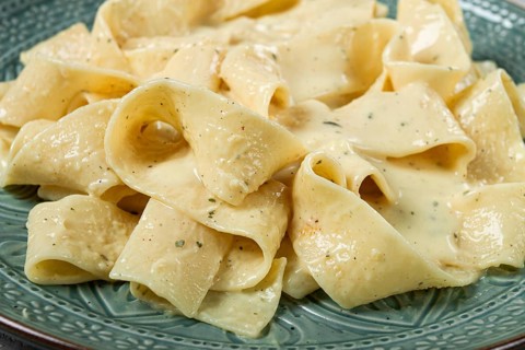 Pasta papardelle in creamy garlic sauce, traditional Italian cuisine, pasta carbonara, homemade, no
