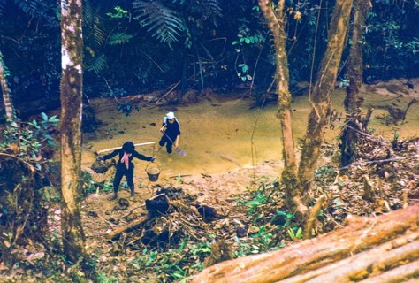 Captioned as 'Chinese women possibly panning for tin in jungle stream', near Fraser's Hill, Pahang,