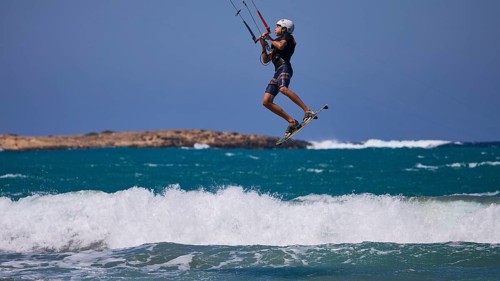 Kitesurfer in the air jumping over the waves in sunny weather, Prasonisi, beach, surf, windsurfer,