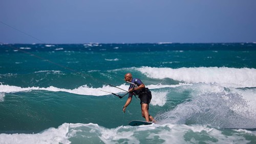 Kitesurfer gliding over the waves in sunny weather and blue sky, Prasonisi, beach, surf,