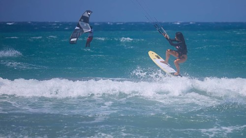 Kitesurfer dynamically jumping over a wave on the open sea, Prasonisi, beach, surf, windsurfer,