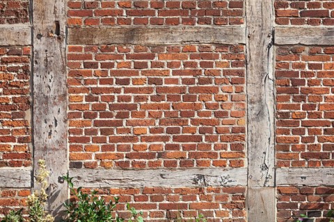 Brick wall and wooden beams on a half-timbered house in the historic centre of Harburg, Harburg,