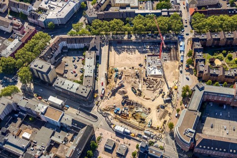 Aerial view, construction site and new building for three-part commercial building complex Viktoria