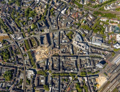 Aerial view, city centre view, construction site and new construction for three-part commercial