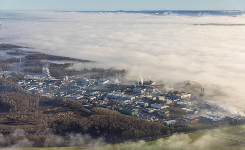 Aerial view, industrial area Westerhaar in fog and mountains of the Sauerland in backlight in