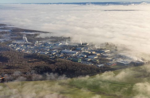 Aerial view, industrial area Westerhaar in fog and mountains of the Sauerland in backlight in