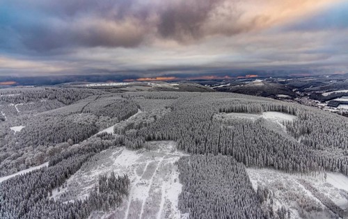 Aerial view of the snowy winter landscape of Winterberg in Sauerland in North Rhine-Westphalia,