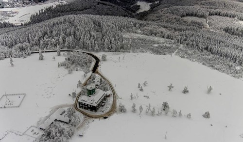 Aerial view of the snowy winter landscape of Winterberg am Kahlen Asten with Astenturm during