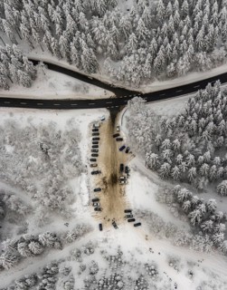 Aerial view of the snowy winter landscape of Winterberg with car park Helleplatz at Kahlen Asten in