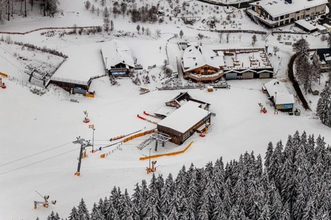 Aerial view of the snowy winter landscape of Winterberg with deserted ski lifts and slopes during