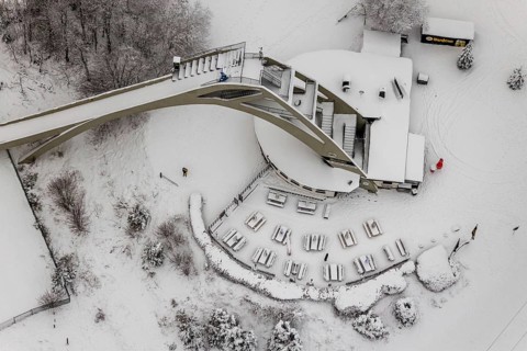 Aerial view of the snowy winter landscape of Winterberg with the St. Georg ski jump in the