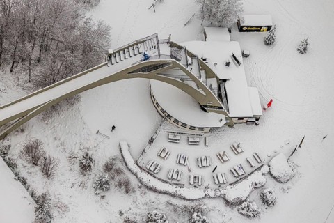 Aerial view of the snowy winter landscape of Winterberg with the St. Georg ski jump in the