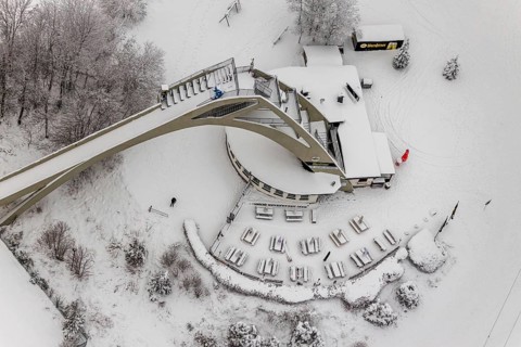 Aerial view of the snowy winter landscape of Winterberg with the St. Georg ski jump in the