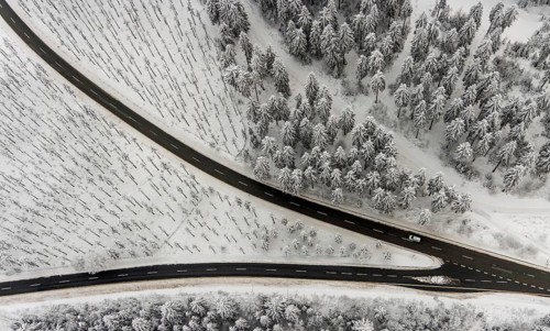 Aerial view of the snowy winter landscape of Winterberg with winding roads and paths with a