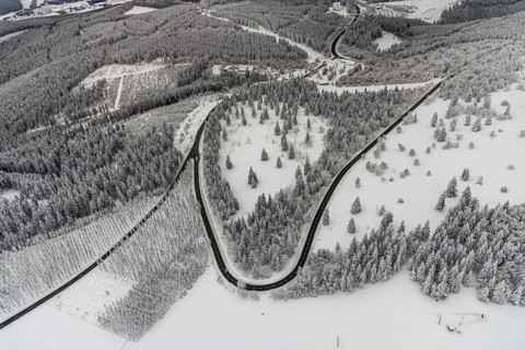 Aerial view of the snowy winter landscape of Winterberg with winding roads and paths in the
