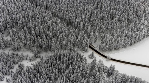 Aerial view of the snowy winter landscape of Winterberg with winding roads and paths in the