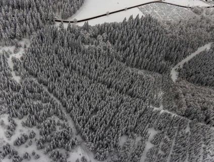 Aerial view of the snowy winter landscape of Winterberg with winding roads and paths in the