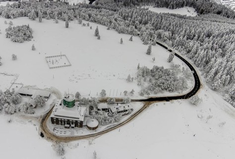 Aerial view of the snowy winter landscape of Winterberg am Kahlen Asten with Astenturm during