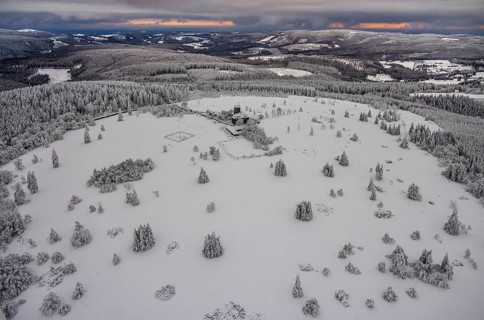 Aerial view of the snowy winter landscape of Winterberg am Kahlen Asten with Astenturm during