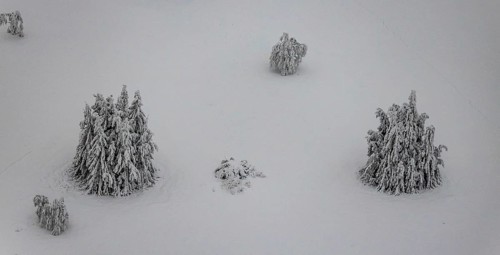 Aerial view of the snowy winter landscape of Winterberg below the Kahler Asten with snow-covered