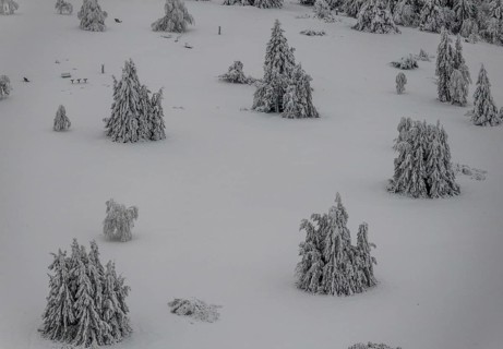 Aerial view of the snowy winter landscape of Winterberg below the Kahler Asten with snow-covered