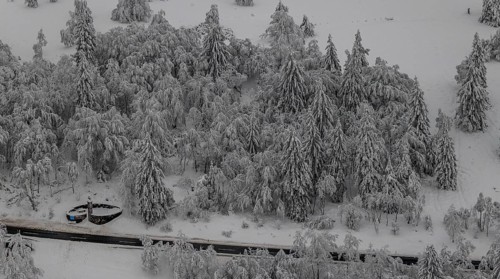 Aerial view of the snowy winter landscape of Winterberg below the Kahler Asten with snow-covered