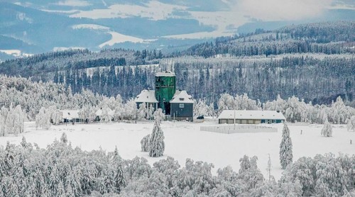Aerial view of the snowy winter landscape of Winterberg am Kahlen Asten with Astenturm during