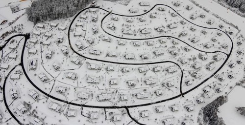 Aerial view of the snowy winter landscape of Winterberg with the deserted Landal Winterberg holiday