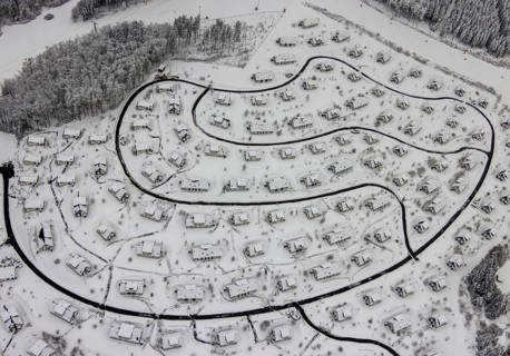 Aerial view of the snowy winter landscape of Winterberg with the deserted Landal Winterberg holiday