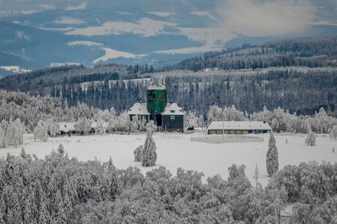 Aerial view of the snowy winter landscape of Winterberg am Kahlen Asten with Astenturm in times of