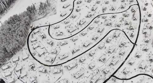 Aerial view of the snowy winter landscape of Winterberg with the deserted Landal Winterberg holiday