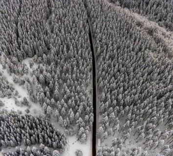 Aerial view of the snowy winter landscape of Winterberg with winding roads and paths in the