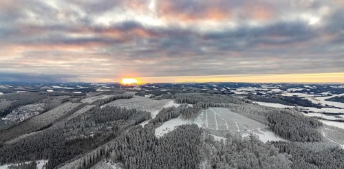 Aerial view of the sunset with a view over the snowy winter landscape from Winterberg to the